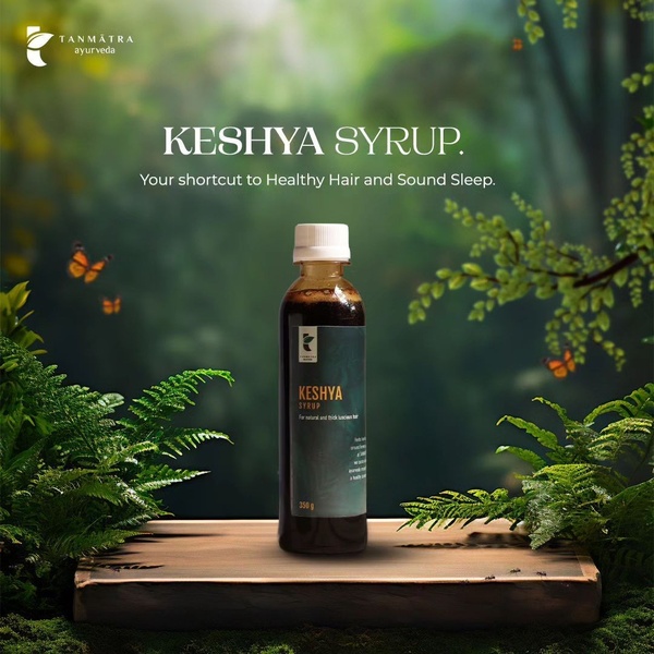 A high-quality product shot of Keshya Syrup centered on a rustic wooden platform, surrounded by lush forest foliage and butterflies.